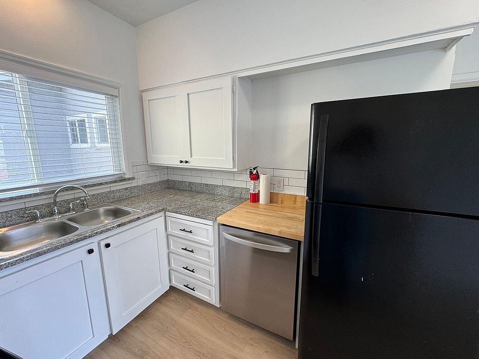 Modern kitchen equipped with essential appliances, including oven, dishwasher, and refrigerator._