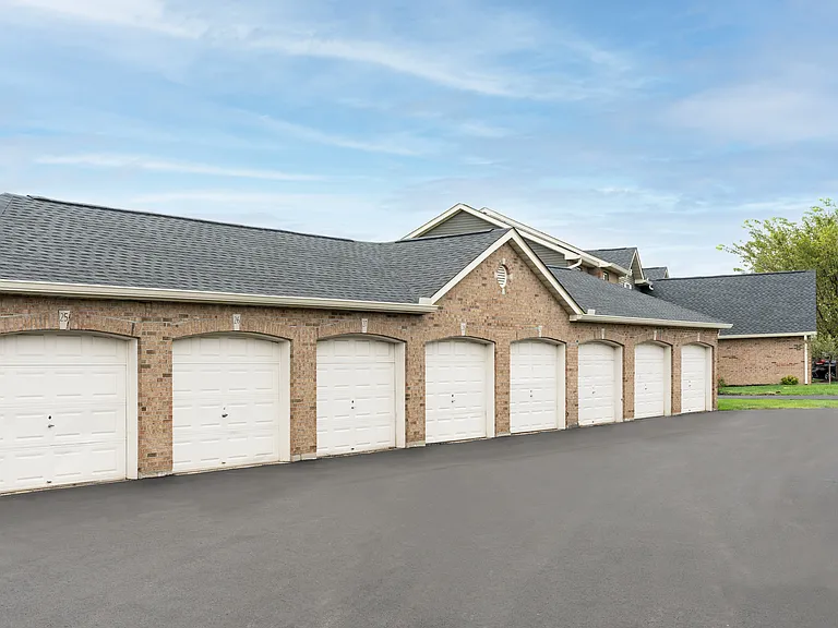 A row of crisp white garage doors adds a sleek, modern touch to the building's exterior.