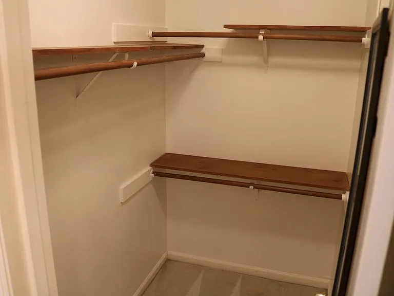 Walk in closet with generous hanging and shelf options.