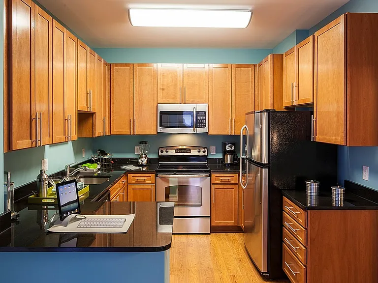 Contemporary Kitchen With Granite Countertops, Wood Cabinets & Stainless Steel Appliances