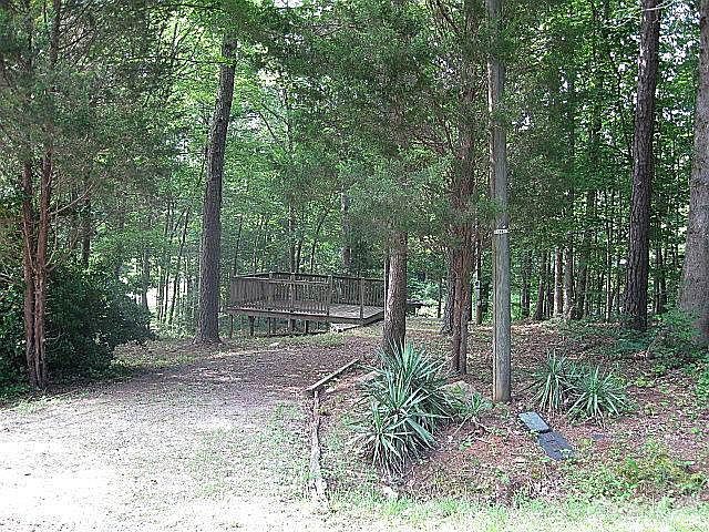 Welcome to 128 Pawnee Drive! Such a pretty, woodsy lot, all ready for your camper!