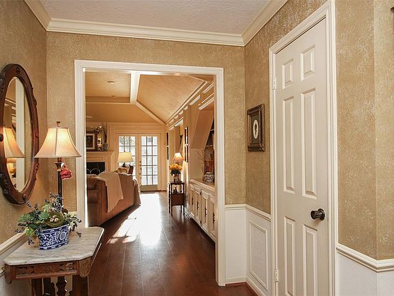 Walking into the foyer, notice the clean sight line to one of the two French doors leading to the amazing backyard and patio.