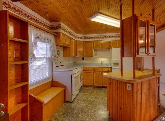 The kitchen opens to the living room and dining room