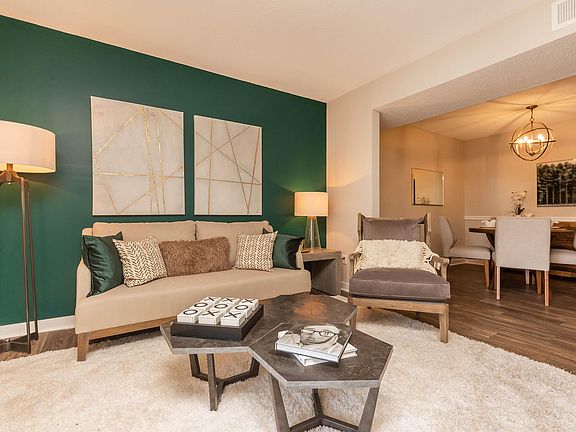 SPACIOUS LIVING ROOM AT MADISON LANDING AT RESEARCH PARK AND THE COTTAGES APARTMENTS