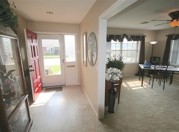 Large Foyer for easy entry and display cases, opens to spacious, bright living.