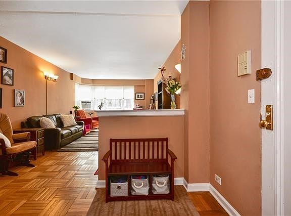 The entry way is a great place to store your mail and keys. This angle shows the large living room. Notice the well-maintained p