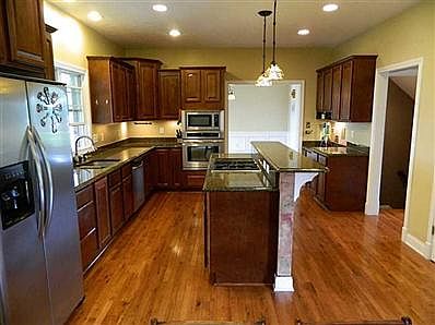 Kitchen. Huge kitchen with granite cntrtps, SS applcs., eat-in counter & bkfst rm. This area, office and foyer ALSO have all hardwood floors. All applcs. in home stay.