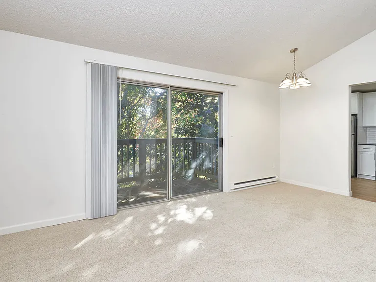 Carpeted Living Room with Balcony