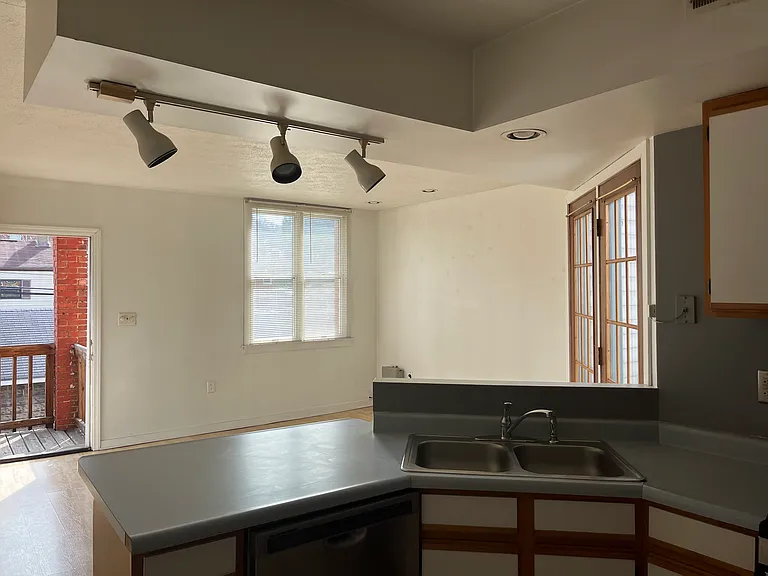 Kitchen to Living Room and Back Entrance to Parking Lot, French Doors to Outdoor Deck