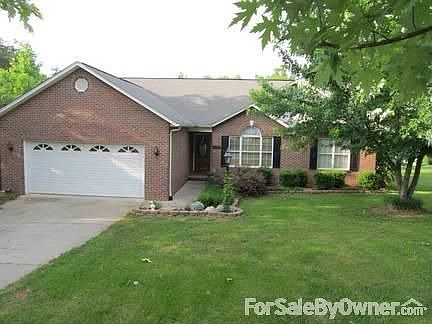 Brick home with nicely landscaped front yard