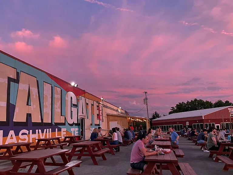 Evening at TailGate Brewery Featuring Wall Mural and Open-Air Seating