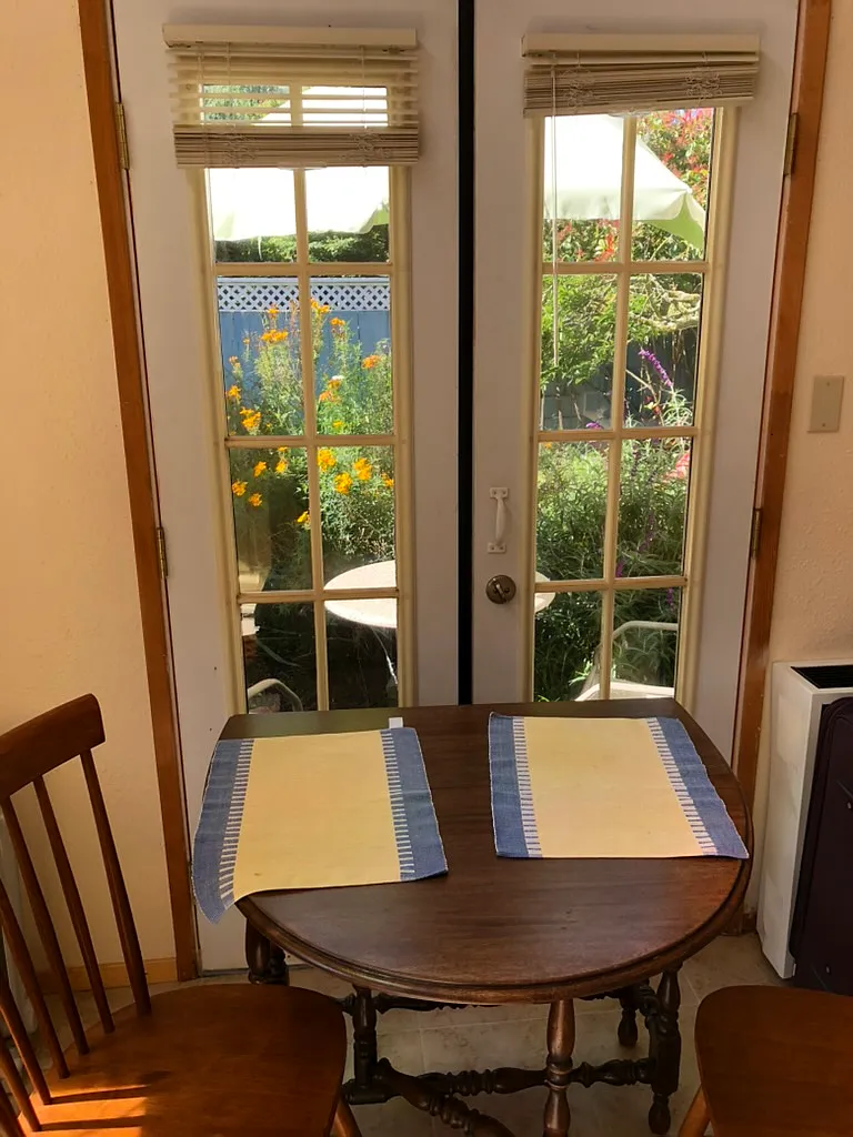 French doors with view of garden; fold out table and chairs - Neilson St