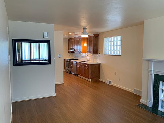 The open concept living/dining area flows into the kitchen. Ceiling fan in the dining area. Luxury vinyl flooring throughout.