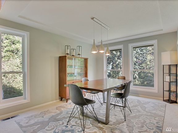 Dining Room With Beautiful View Of Trees & Green Grass