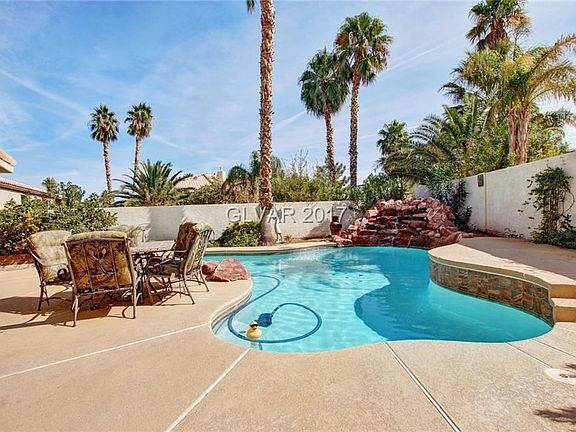 Huge backyard with sparkling pool & waterfall