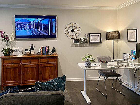 First floor bonus room with office space and half bathroom (access to the garage on right wall)