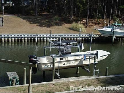 Canal Front : Dock with boat lift on approximately 70 ft water frontage.