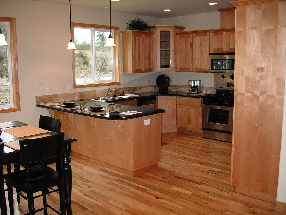Kitchen has granite counter tops and hickory cabinets