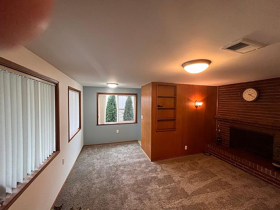 Lots of natural light and a working fireplace. New carpet and paint. Privacy blinds. Updated bath.