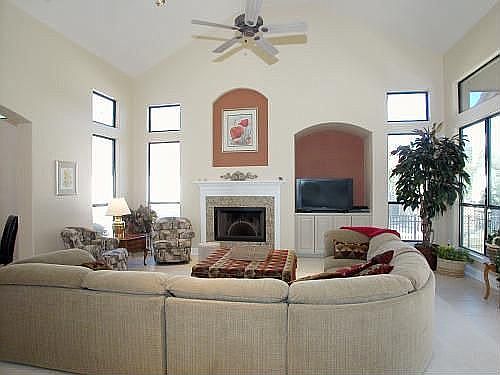 Large Great Room has high ceilings, fireplace, and lots of windows