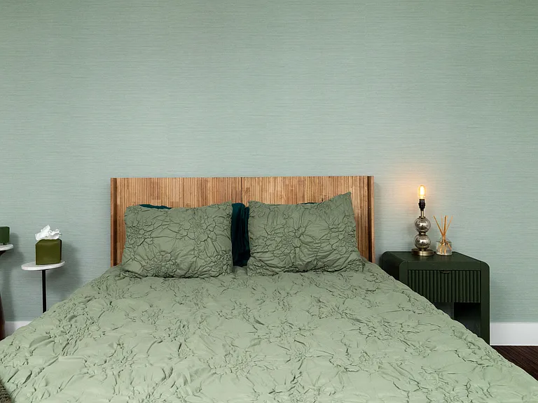 Rest in a calming bedroom with soft green tones, warm lighting, and a cozy bench at the foot of the bed. Enjoy a large TV, stylish dresser, and easy access to a spacious walk-in closet for a relaxing, comfortable stay.