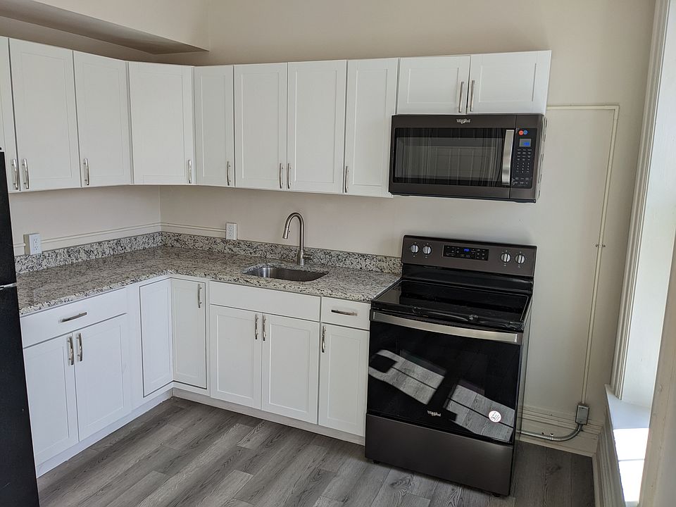 Kitchen with granite counters, electric appliances, and natural light (windows face N Third St)
