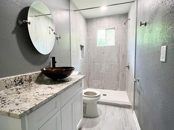 New Master bathroom addition with custom tile, shower, toilet, paint, granite countertop, plumbing, sink, vanity, and flooring.