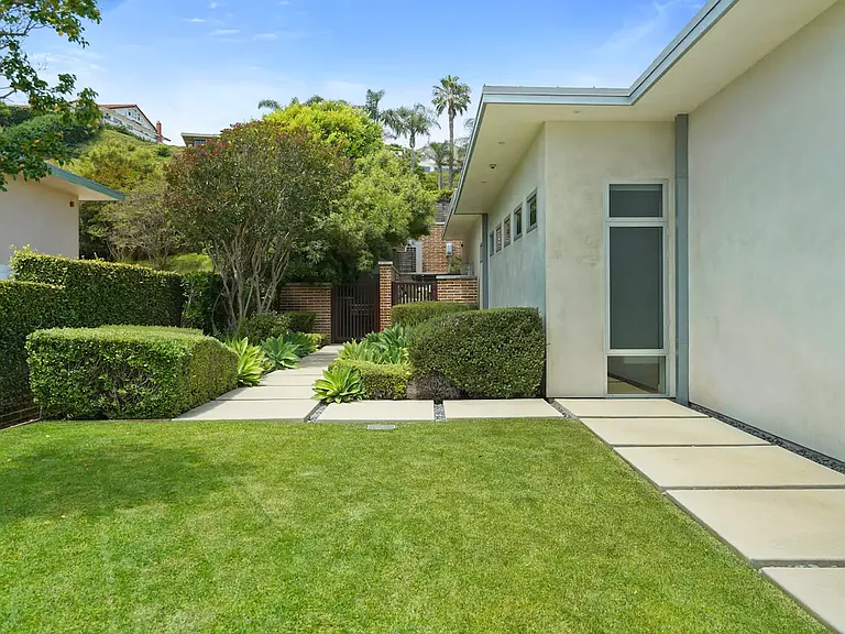 Explore a lush, landscaped garden with vibrant, meticulously maintained grass.