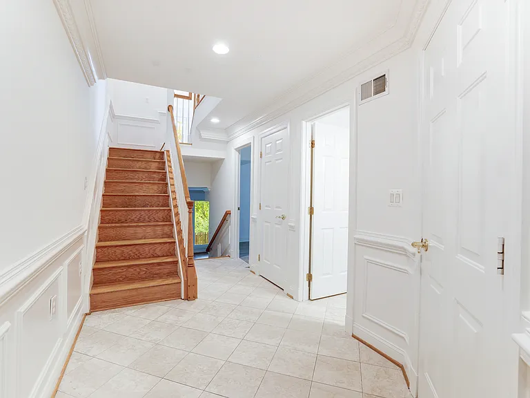 Entry level with bedroom, bathroom and family room with fireplace. Stairs leading upstairs to main living level with another family room with fireplace, large deck, kitchen, dining room and living room with a view of the monuments