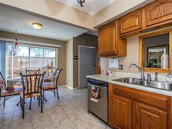Kitchen provides ample storage and entertaining space opening to private, enclosed patio