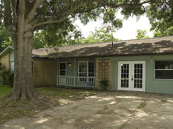 The garage was converted and now the driveway leads to French doors that open to the large game room.