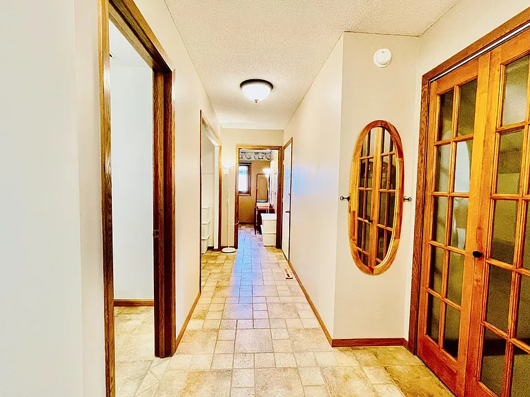Next to the hallway leads to the Main Floor half bathroom, Mudroom (facing the garage door entry, and at the end the Laundry Room)