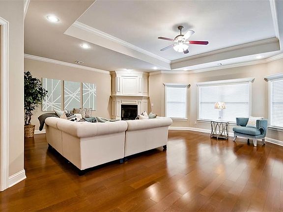 HUGE Main Living space - with Beautiful Bay Windows - Hardwood Floors - Tray Ceilings - Stunning Fireplace Surround - and enough space for multiple, flexible seating space...
