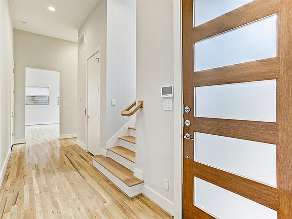 Open the door to prestige and elegance! A gracious foyer with white oak hardwood floors that leads to the first floor living area.