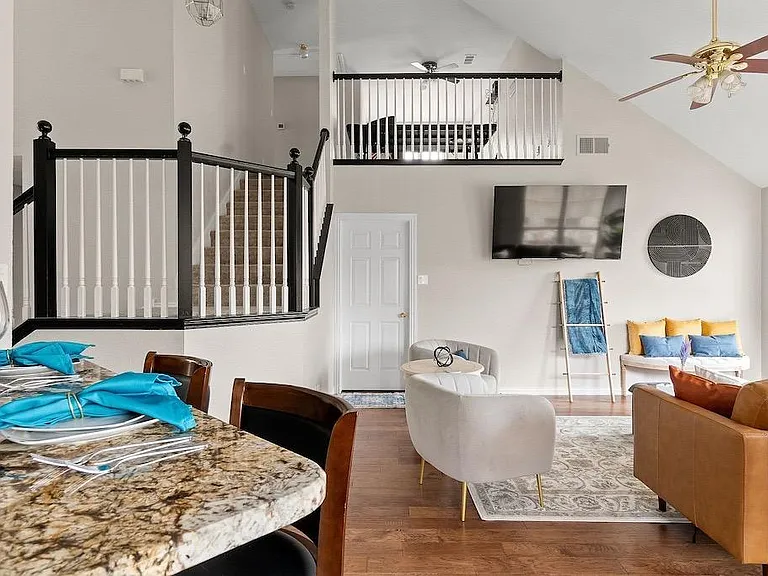 From dining looking into living room and upstairs game-room. 
Kitchen bar has 2 high end bar stools with leather upholstery and swivel for your comfort.