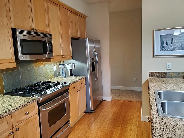 Kitchen with stainless steel appliances, dishwasher, refrigerator, garbage disposal, gas cooktop