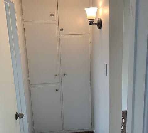 Hall linen closet with plenty of storage.