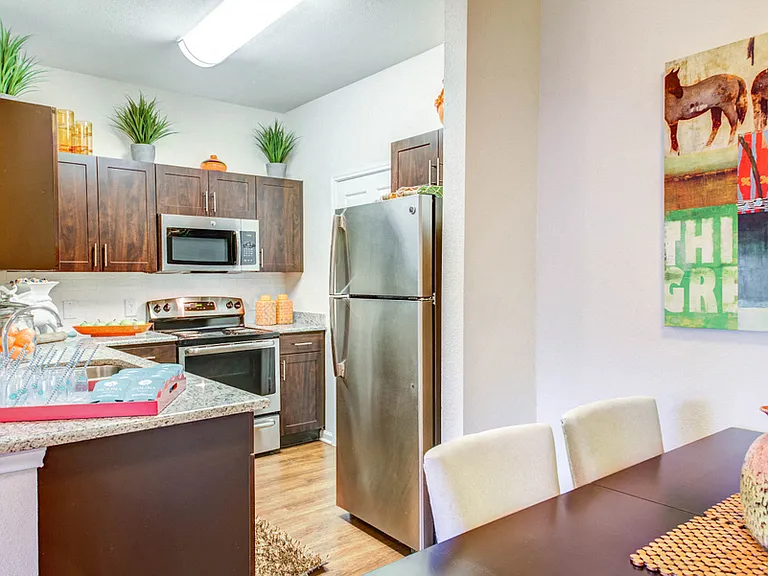 Dinning room looking into kitchen with stainless steal appliances