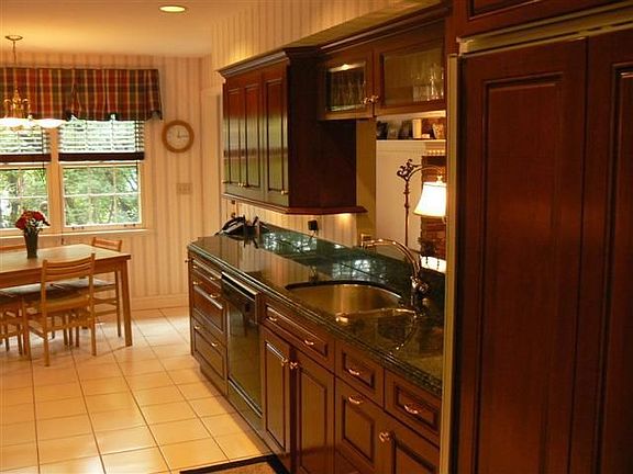 Cherry wood cabinetry with pullouts, granite counters, Sub-Zero frig.