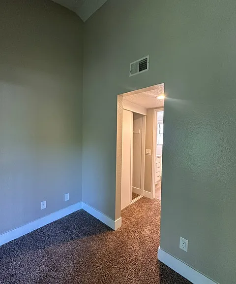 Bedroom 1 view into walk thru closets into bathroom