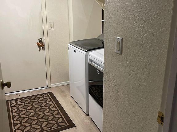 Laundry room with washer dryer and utility sink.
