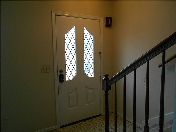 The stairway to the upper two bedrooms is just inside the door.