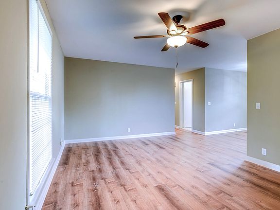 view from the front door into the living room. In the photo the kitchen is to the right and the bedrooms are down the hall to the left
