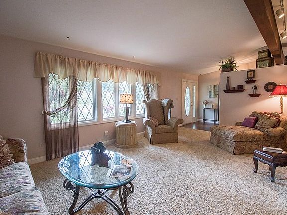 Another view of the Living Room features the large windows framing the front yard.