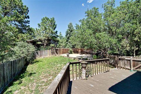 Large side yard with basket ball court area