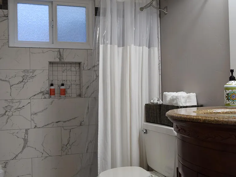 The bathroom has a ceiling mounted heater plus valves that maintain the water temperature without fluctuating.