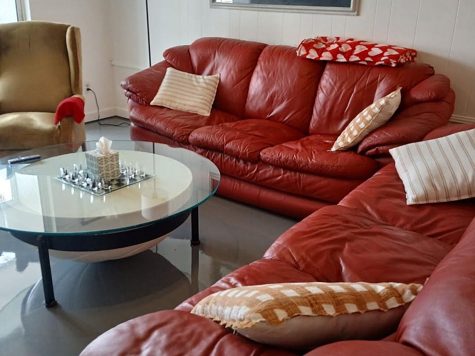 Living room couch faces flat screen tv - enter lanai from here