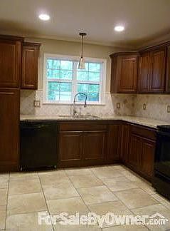 Kitchen : Granite Countertops. Undermount Stainless Steel Sink. Travertine backsplash.
