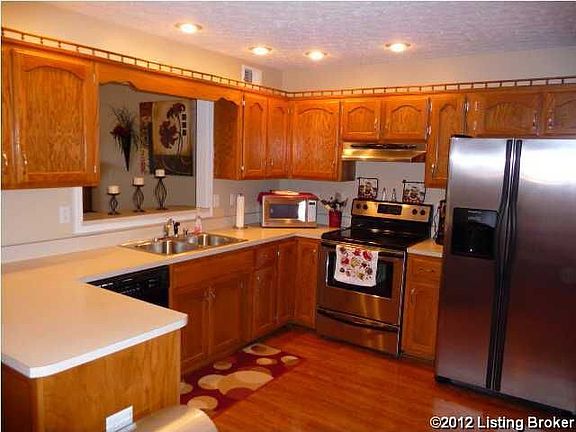 Large kitchen with stainless steel appliances.