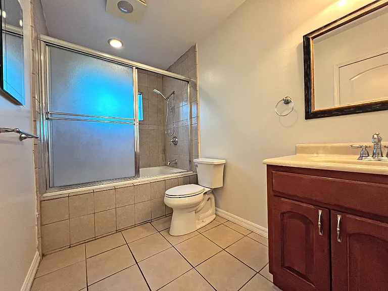 Primary bathroom with large jetted soaking tub and full shower.